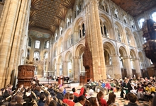 Children seated in the Nave Crossing at a Katharine of Aragon Festival event