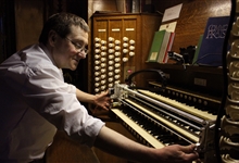 Ben Trenchard with the robot in the organ loft