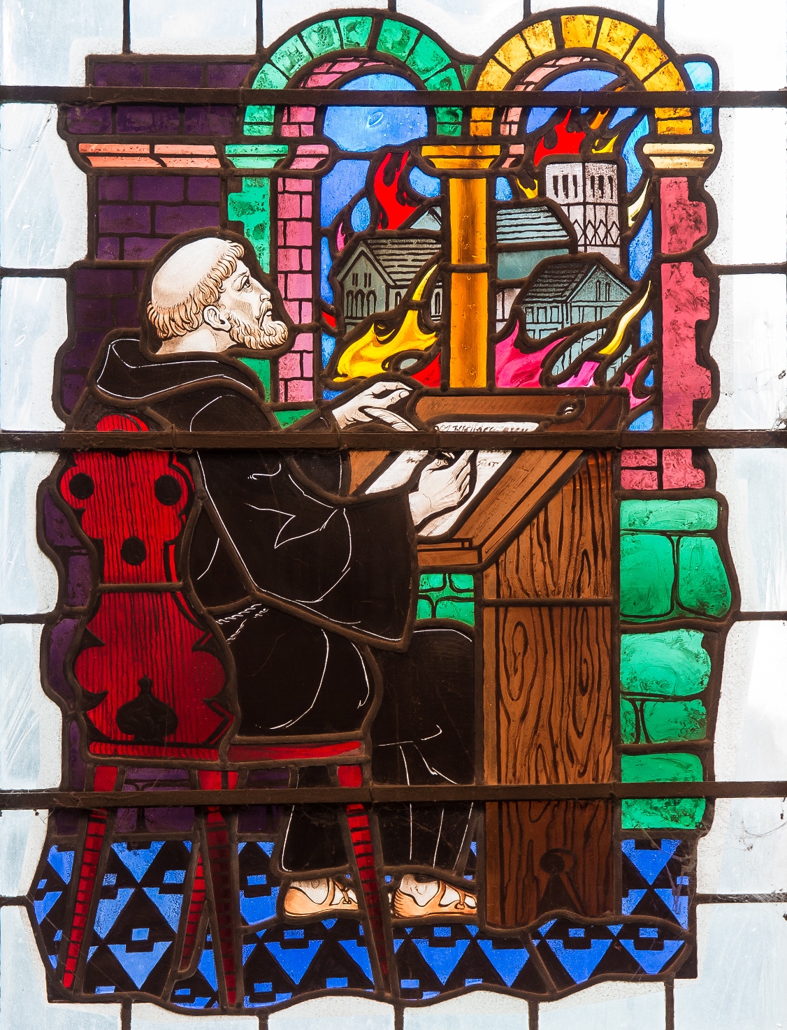 The fire and writing the Chronicle, as depicted in the Benedict Chapel window.